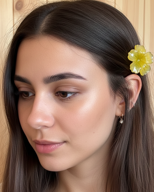 Woman with a yellow flower in her hair against a wooden background