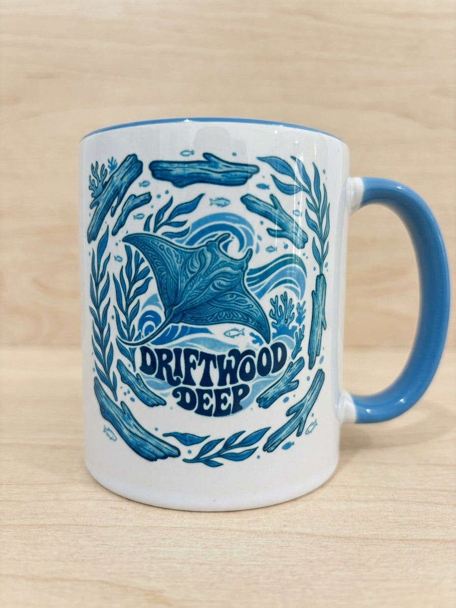 White mug with green interior and handle featuring a scuba diving and tea design on a wooden surface.