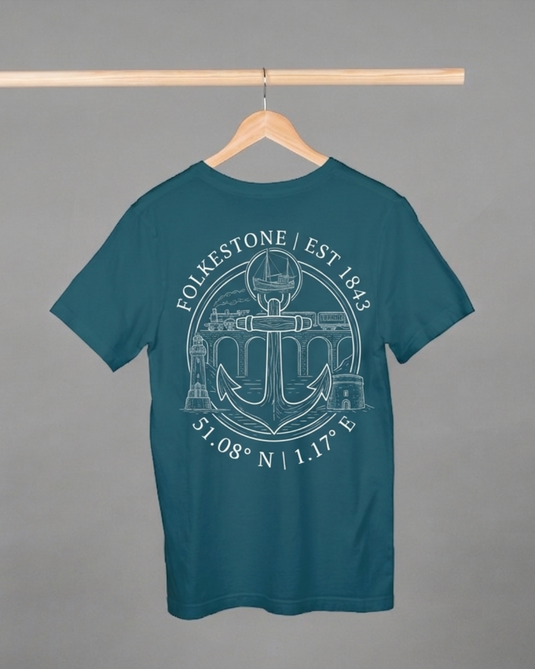 Teal t-shirt with white graphic design on a hanger against a gray background