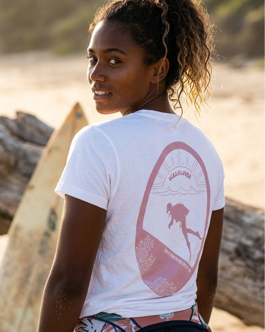 Woman wearing a white t-shirt with a graphic design on the beach