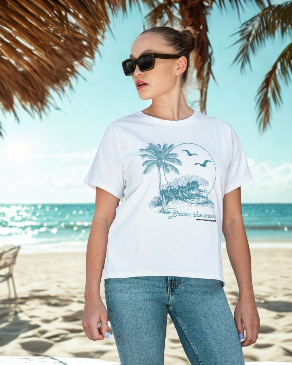 Woman wearing a white t-shirt with a palm tree design on a beach