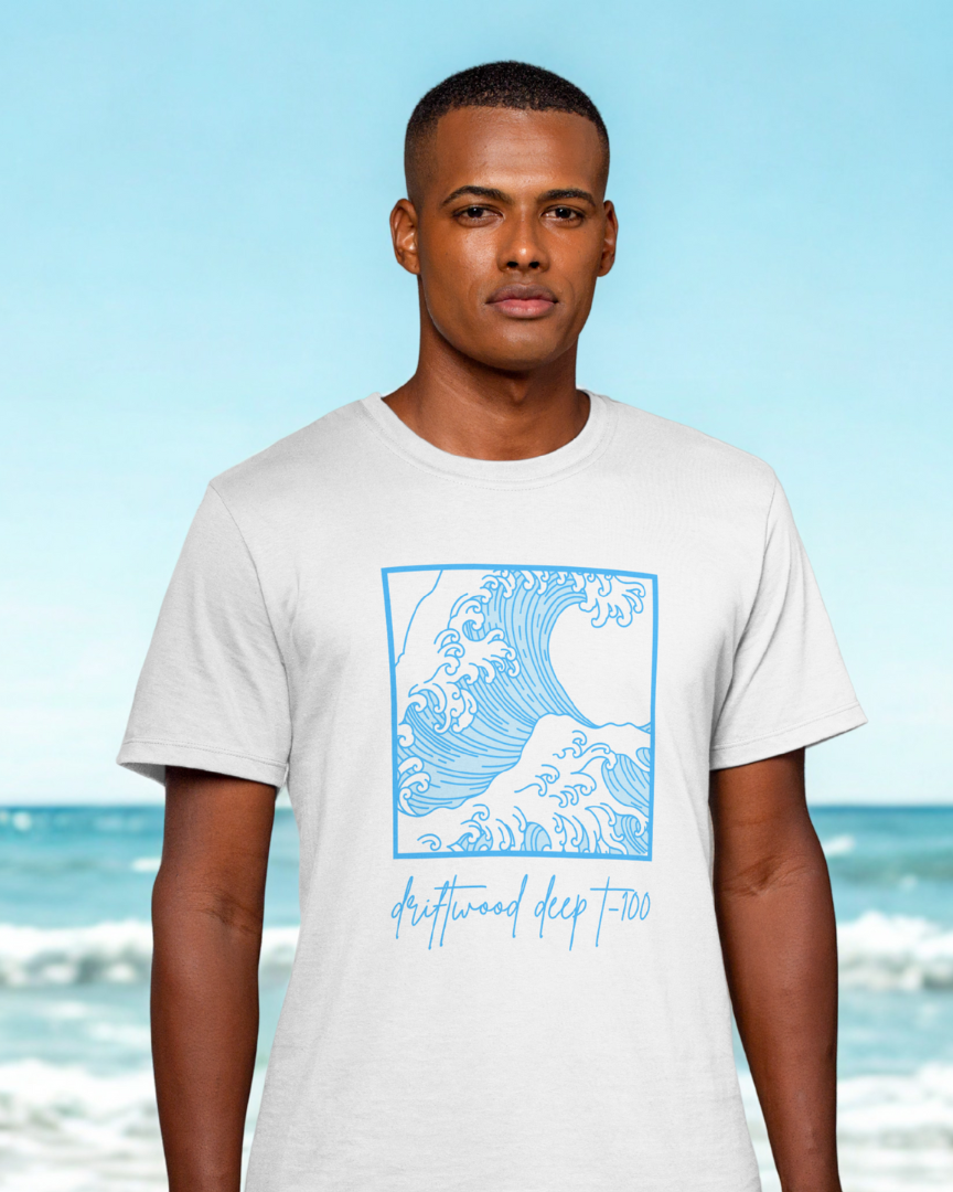 Man wearing a white t-shirt with a blue graphic on a beach