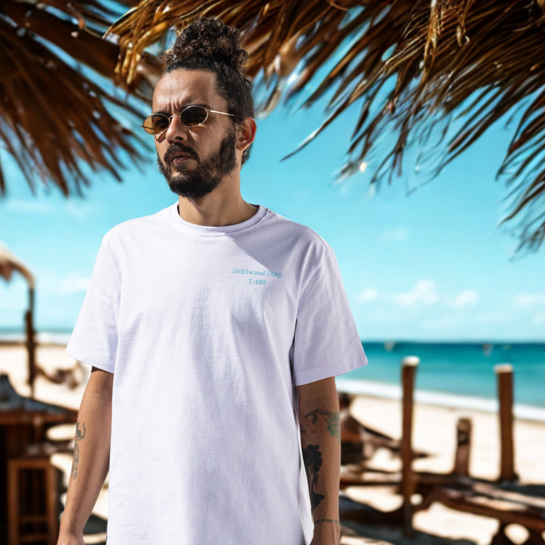 Man wearing a white t-shirt with a beach and ocean background