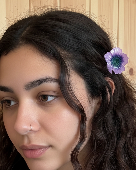 Woman with a purple flower in her hair against a wooden background