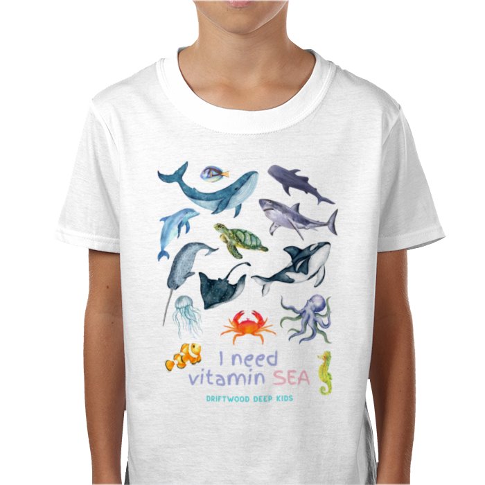 A child wearing a white t-shirt with a graphic print of various sea creatures and the text 'I need vitamin SEA'.