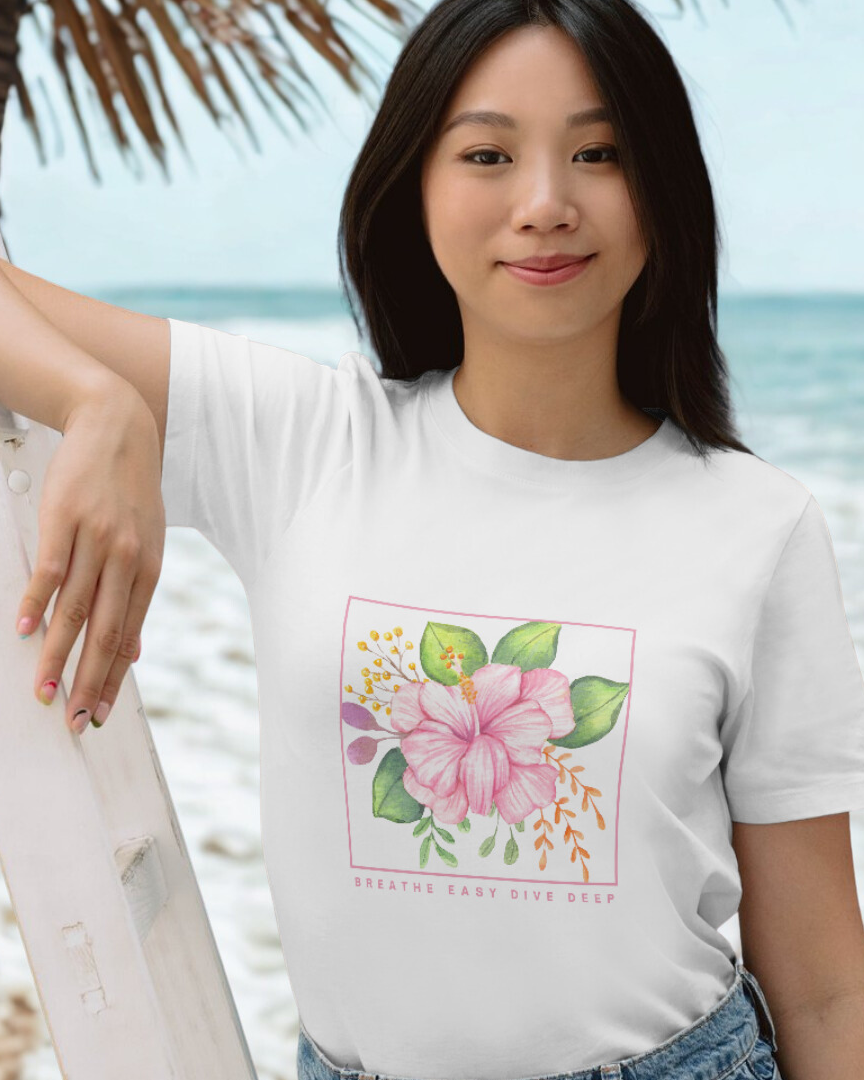 Woman wearing a white t-shirt with a floral design on a beach