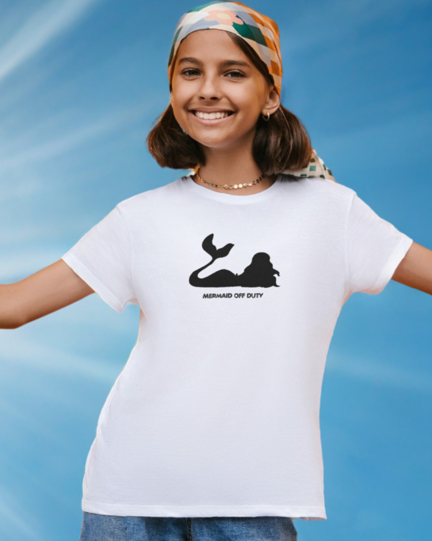 Person wearing a white t-shirt with a black graphic design against a blue sky background