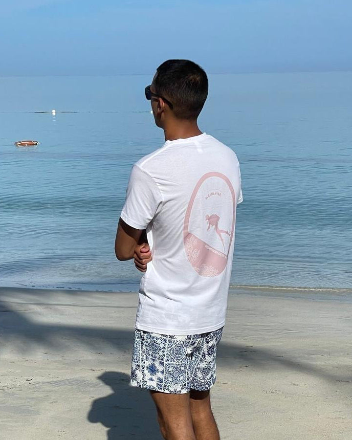 Person standing on a beach looking at the ocean