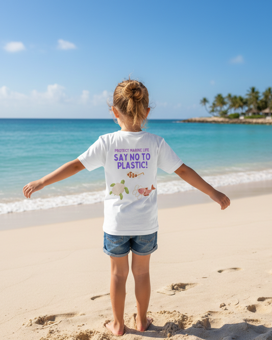 Child standing on a beach wearing a 'Say No to Plastic' t-shirt with arms outstretched.