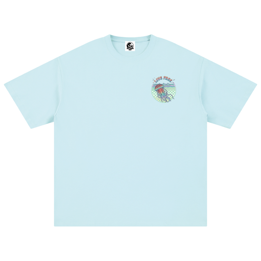 A light blue short-sleeve crewneck t-shirt with a small multicolour graphic on the left chest depicting a jellyfish.