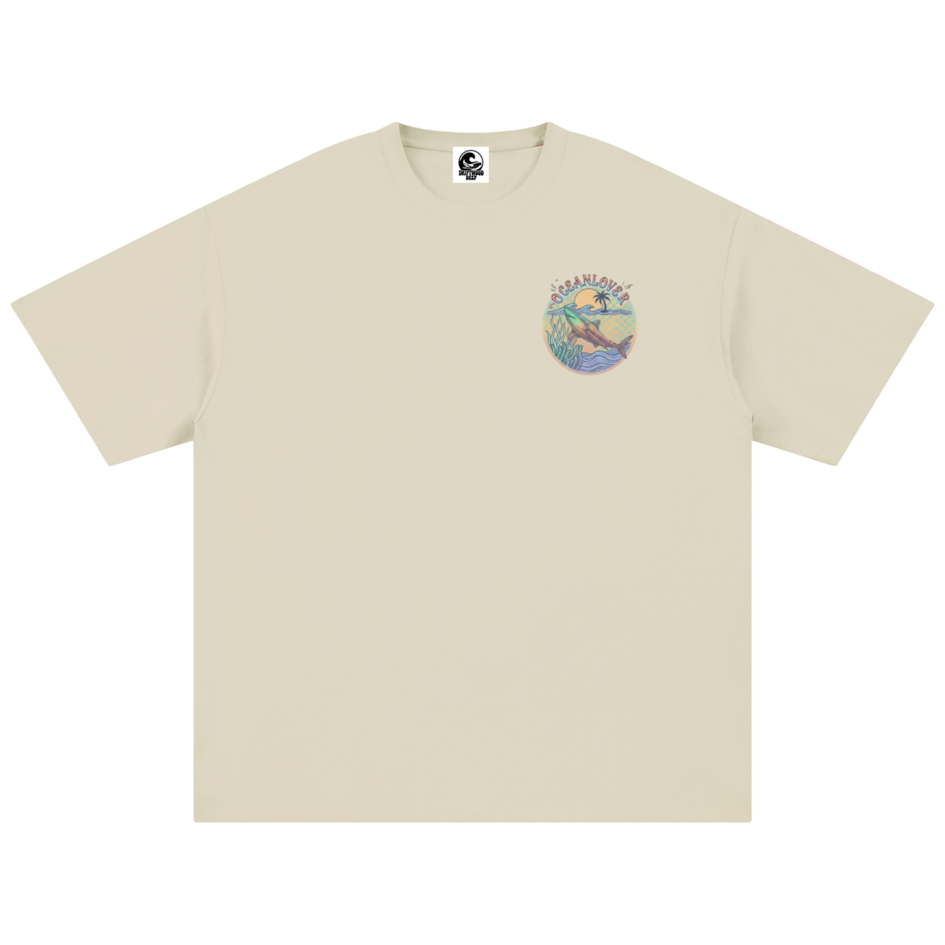 A light beige crewneck t-shirt with a small circular multicolour graphic on the left chest depicting a shark.