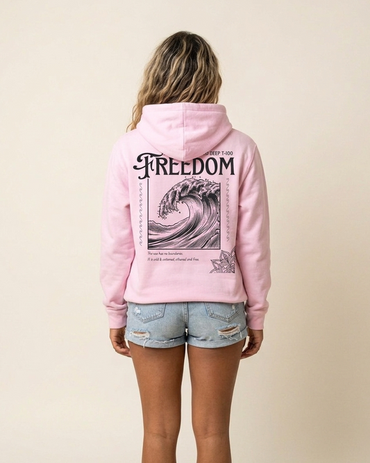 Person wearing a pink hoodie with 'Freedom' text and wave graphic on the back, standing against a beige background.