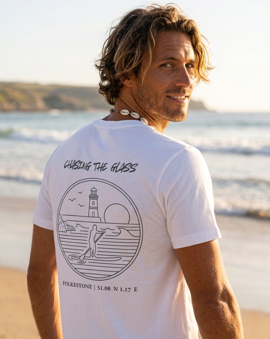 Man wearing a white t-shirt with a graphic design on the beach