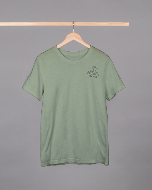Green t-shirt with a small logo on a hanger against a gray background