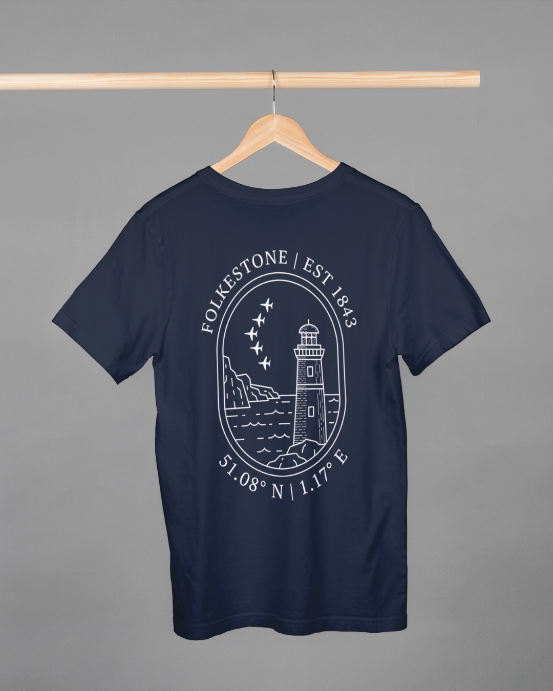 Navy blue t-shirt with white graphic design on a hanger against a gray background