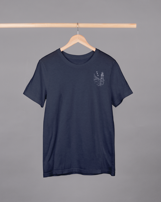 Navy blue t-shirt with a small graphic on a hanger against a gray background