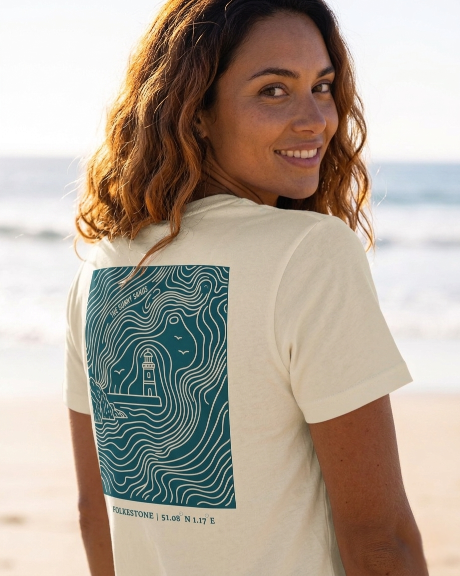 Woman wearing a t-shirt with a lighthouse design on the beach
