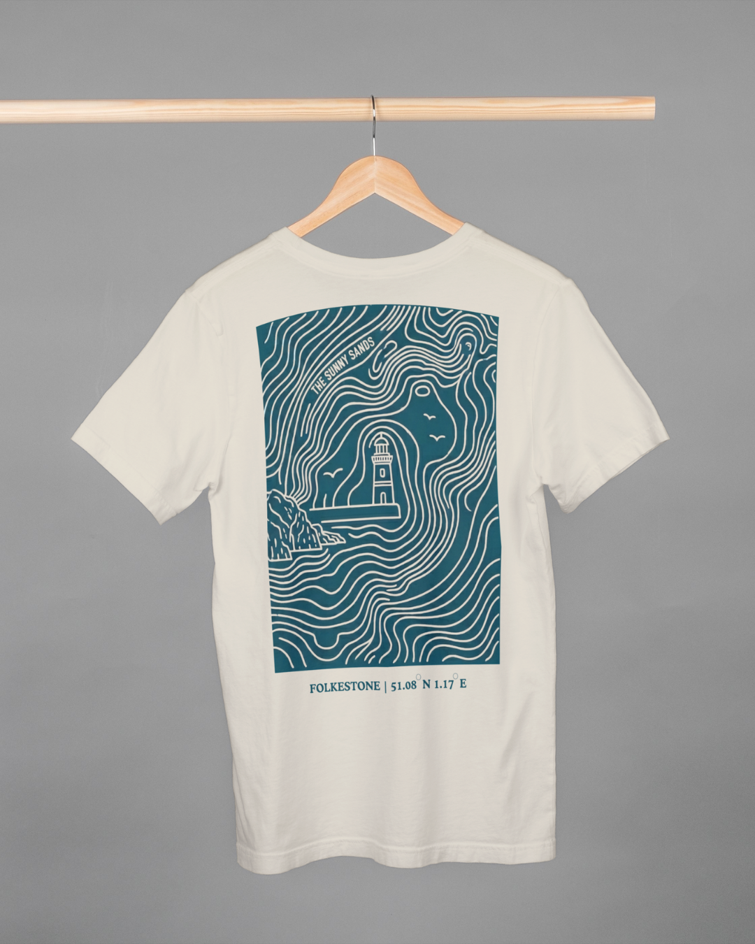 White t-shirt with teal graphic design on a hanger against a gray background