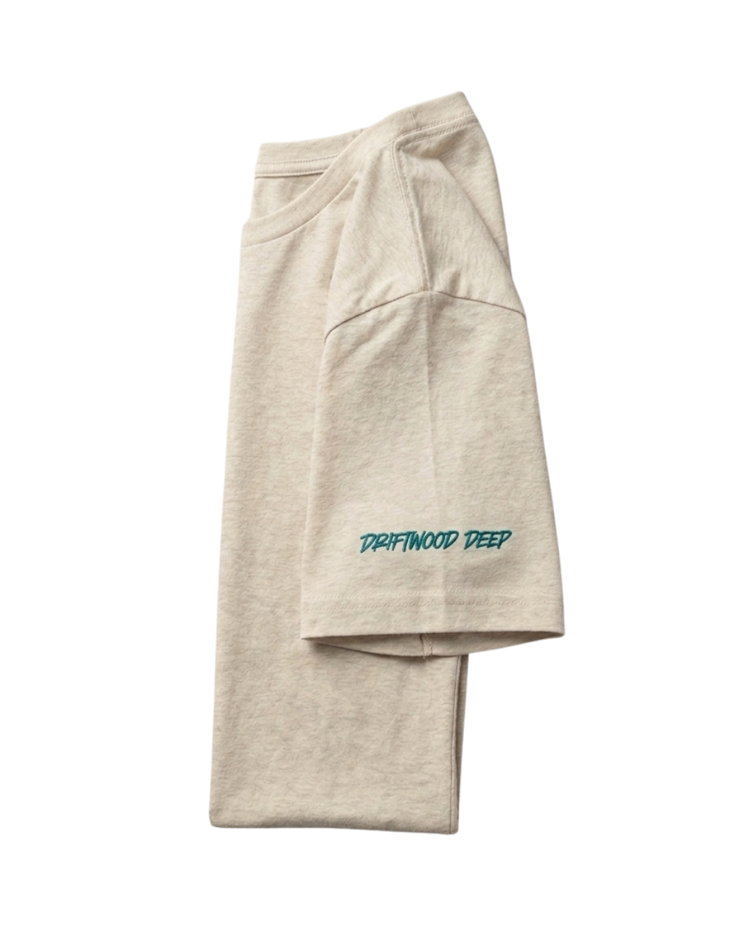 A folded light beige heathered sweatshirt or hoodie with teal embroidered text reading 'DRAFTWOOD DEEP' on the sleeve, shown on a plain white background.